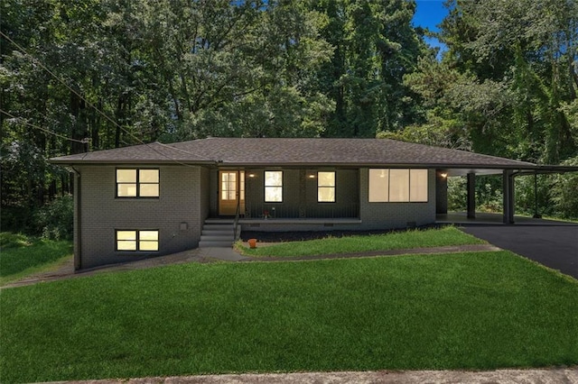 view of front of house with a front yard and a carport