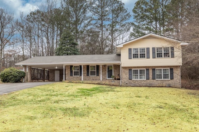 split level home featuring a carport and a front yard