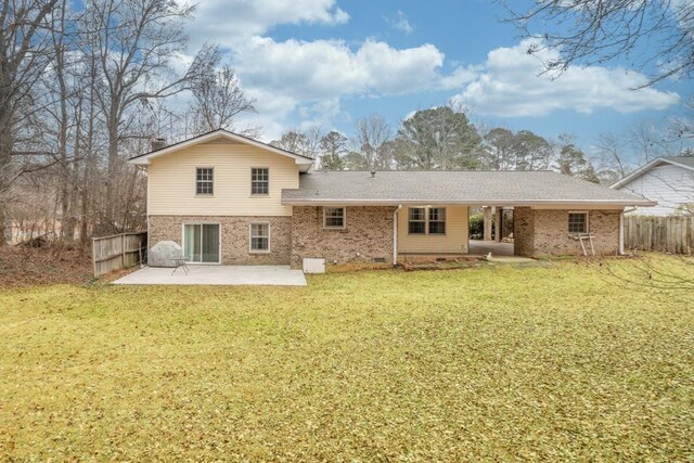 back of property with a lawn and a patio area