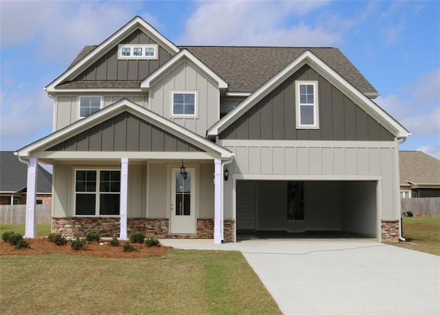 1023 Boulder Dr, Gray, GA 31032 - craftsman-style home with board and batten siding, a shingled roof, concrete driveway, stone siding, and a front lawn
