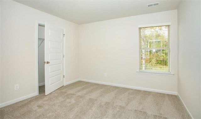 1023 Boulder Dr, Gray, GA 31032 - spare room featuring baseboards, visible vents, and light colored carpet