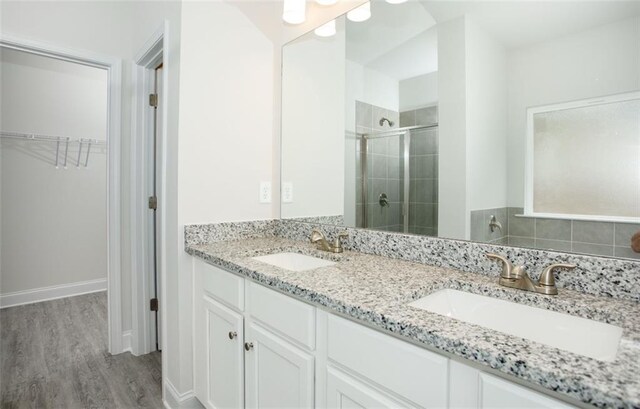 1023 Boulder Dr, Gray, GA 31032 - full bath featuring wood finished floors, a stall shower, a spacious closet, and a sink