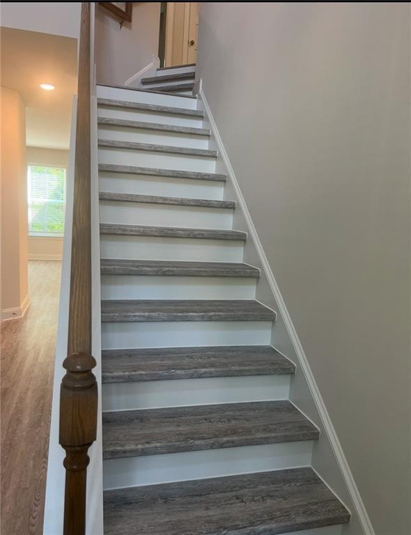 1023 Boulder Dr, Gray, GA 31032 - staircase featuring wood finished floors and baseboards