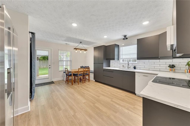 15 Echota Rd NE, Cartersville, GA 30121 - kitchen featuring dishwasher, light wood-style floors, decorative backsplash, healthy amount of natural light, and a textured ceiling