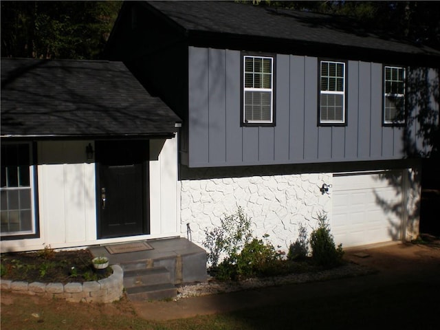 exterior space with an attached garage and entry steps