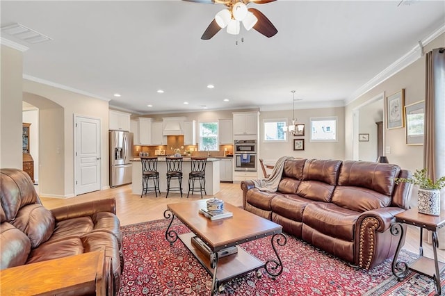 2920 Farmstead Way, Suwanee, GA 30024 - living area with ceiling fan, ornamental molding, arched walkways, light wood finished floors, and recessed lighting