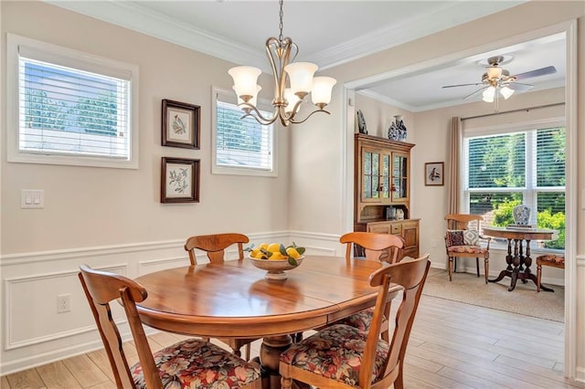 2920 Farmstead Way, Suwanee, GA 30024 - dining area with healthy amount of natural light, ornamental molding, light wood-style flooring, wainscoting, and a chandelier