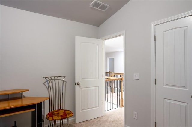 corridor with vaulted ceiling, carpet, an upstairs landing, and visible vents