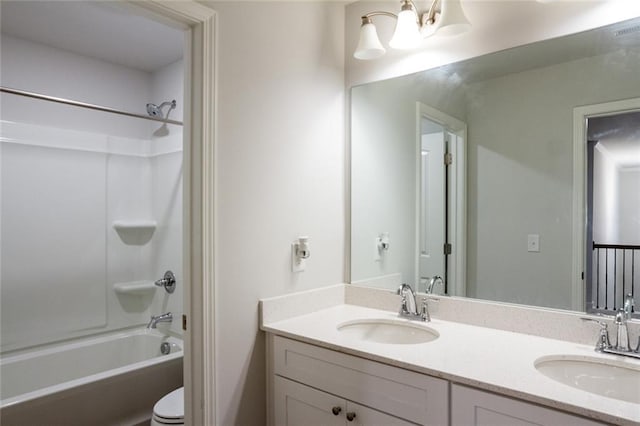 bathroom with double vanity, shower / washtub combination, and a sink