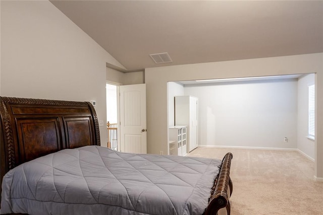 bedroom with carpet floors, baseboards, visible vents, and lofted ceiling