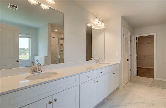 full bath featuring double vanity, marble finish floor, visible vents, and a sink