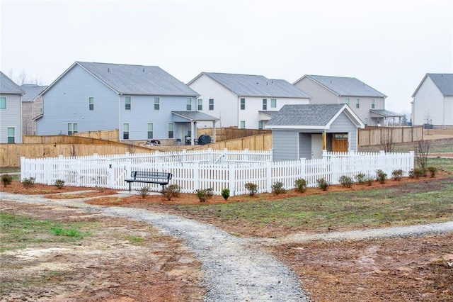 view of yard featuring a fenced front yard and a residential view