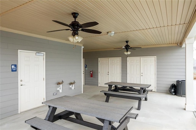 view of patio with outdoor dining area and a ceiling fan