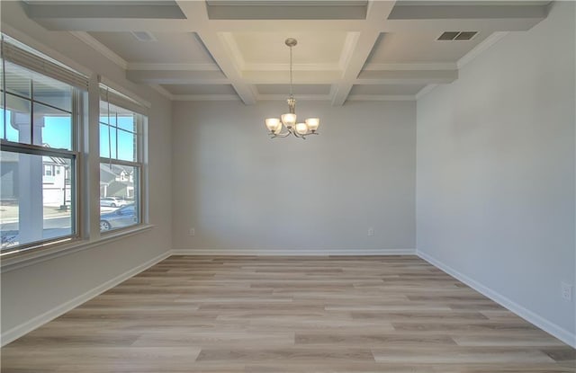 empty room featuring light wood-type flooring, visible vents, a notable chandelier, and baseboards