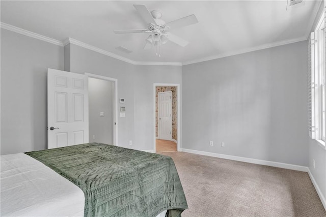 bedroom with carpet flooring, crown molding, baseboards, a ceiling fan, and ensuite bath