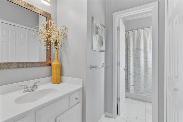 full bathroom featuring tile patterned floors, vanity, curtained shower, and baseboards