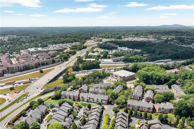 drone / aerial view of a major roadway and a heavily wooded area