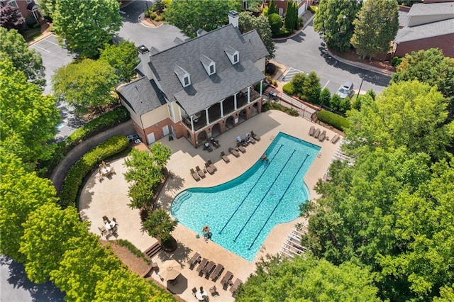 aerial view of property and surrounding area featuring a pool area