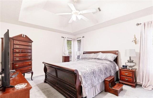 4014 Ivy Trace Ln, Ellenwood, GA 30294 - bedroom with light colored carpet, baseboards, a raised ceiling, visible vents, and a ceiling fan