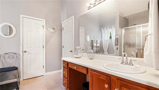 4014 Ivy Trace Ln, Ellenwood, GA 30294 - bathroom featuring vanity, baseboards, and a shower stall