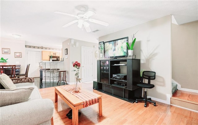 4014 Ivy Trace Ln, Ellenwood, GA 30294 - living room featuring baseboards, light wood-style floors, ceiling fan, and visible vents