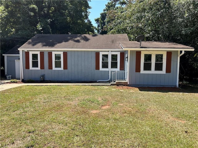 single story home with a front yard and board and batten siding