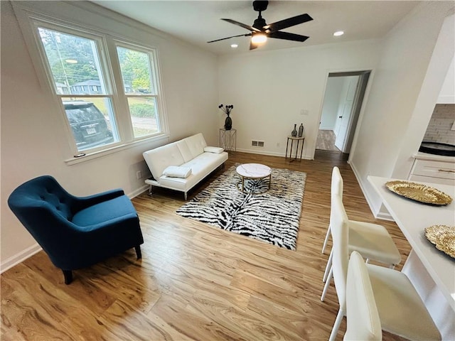 sitting room featuring visible vents, baseboards, ceiling fan, and wood finished floors