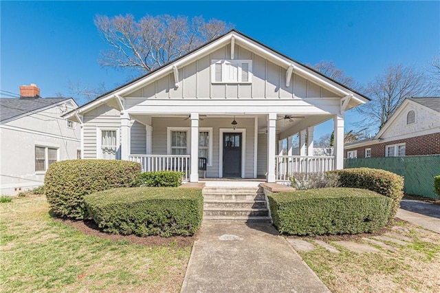 bungalow-style home with board and batten siding, covered porch, and ceiling fan