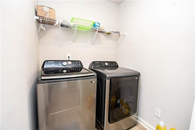 laundry area with hardwood / wood-style flooring and washer and clothes dryer