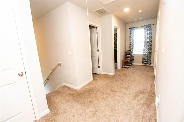 hallway with light colored carpet