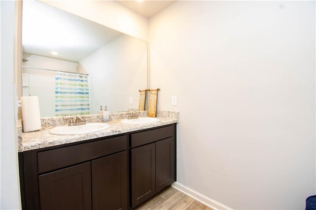 bathroom featuring hardwood / wood-style flooring, vanity, and a shower with shower curtain