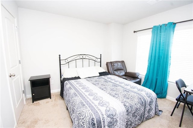 bedroom featuring light colored carpet