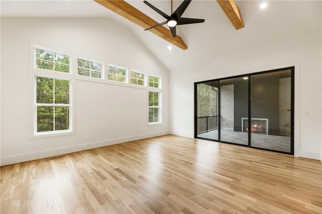 interior space with beam ceiling, ceiling fan, light hardwood / wood-style flooring, and high vaulted ceiling