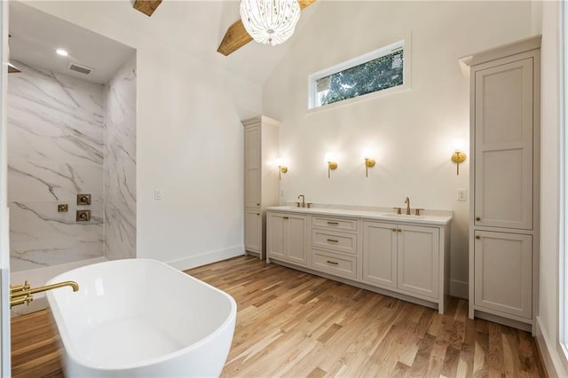 bathroom with wood-type flooring, vanity, and a tub