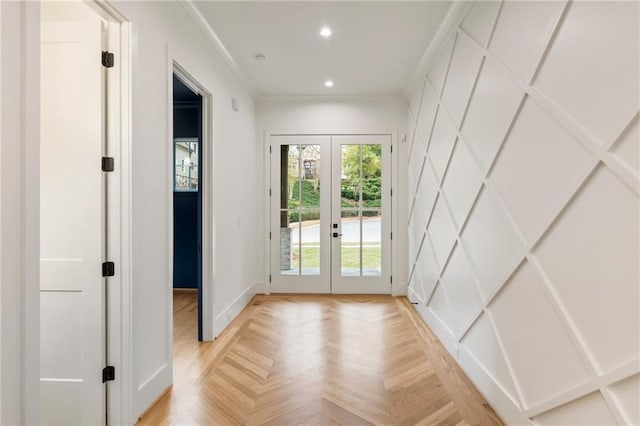 doorway featuring light parquet flooring, ornamental molding, and french doors