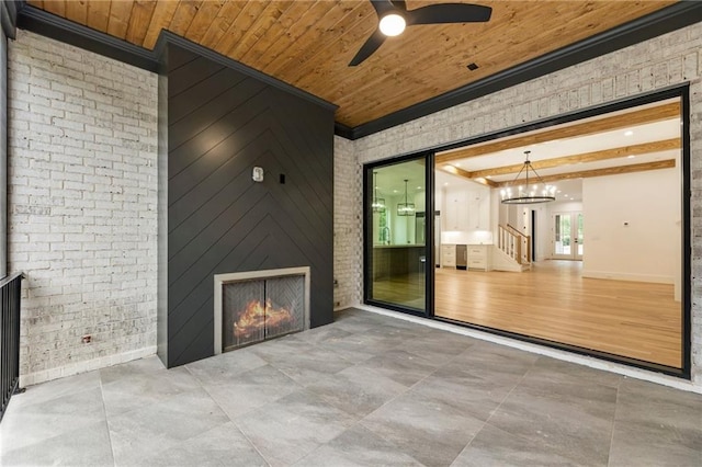 view of patio with ceiling fan and a large fireplace