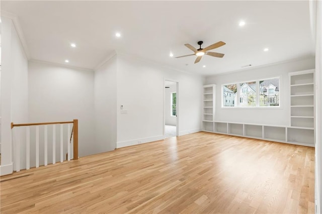 empty room featuring ceiling fan, light hardwood / wood-style floors, and ornamental molding