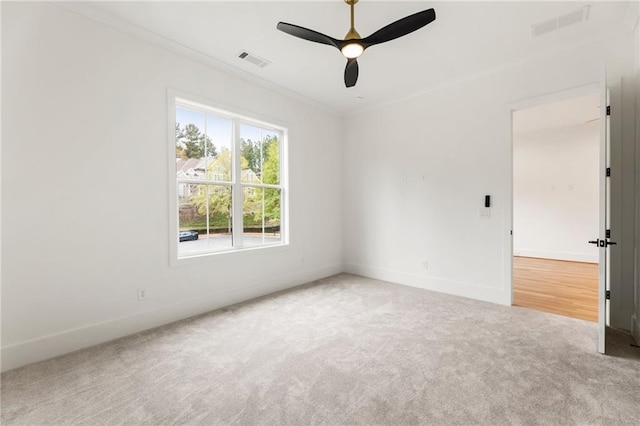 carpeted empty room featuring ceiling fan and ornamental molding