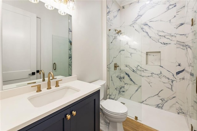 bathroom featuring hardwood / wood-style floors, vanity, toilet, and walk in shower