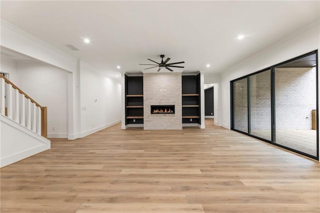 unfurnished living room featuring crown molding, ceiling fan, and light hardwood / wood-style floors