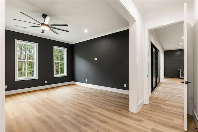 unfurnished room featuring crown molding, ceiling fan, and light hardwood / wood-style floors