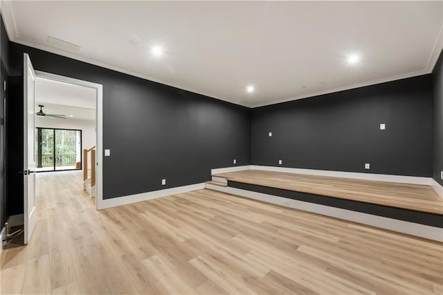 spare room featuring ceiling fan, light wood-type flooring, and ornamental molding