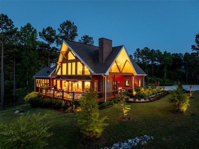 back of house featuring a yard and a wooden deck