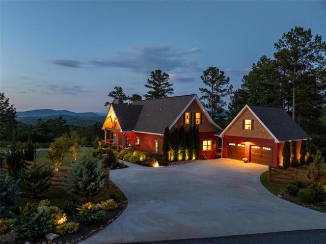 view of front of home with a mountain view and a garage