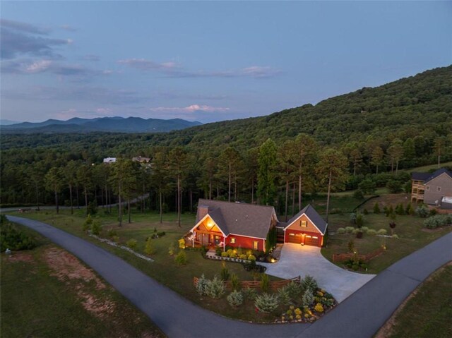 aerial view at dusk featuring a mountain view