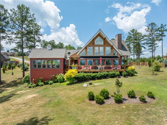 back of house featuring a deck and a yard