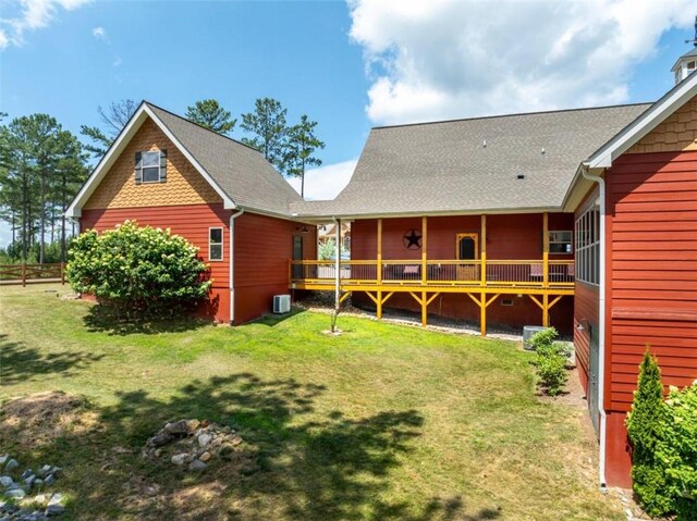 rear view of property with a lawn