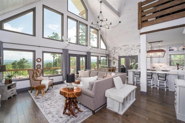 living room featuring beamed ceiling, french doors, a chandelier, high vaulted ceiling, and dark hardwood / wood-style floors