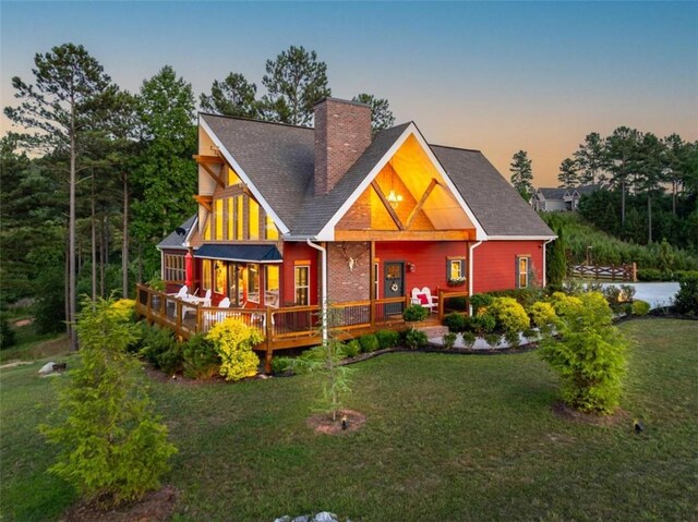 view of front of property featuring a yard and a wooden deck