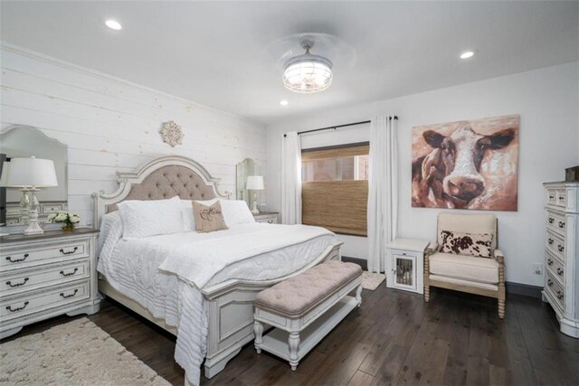 bedroom featuring wooden walls and dark wood-type flooring